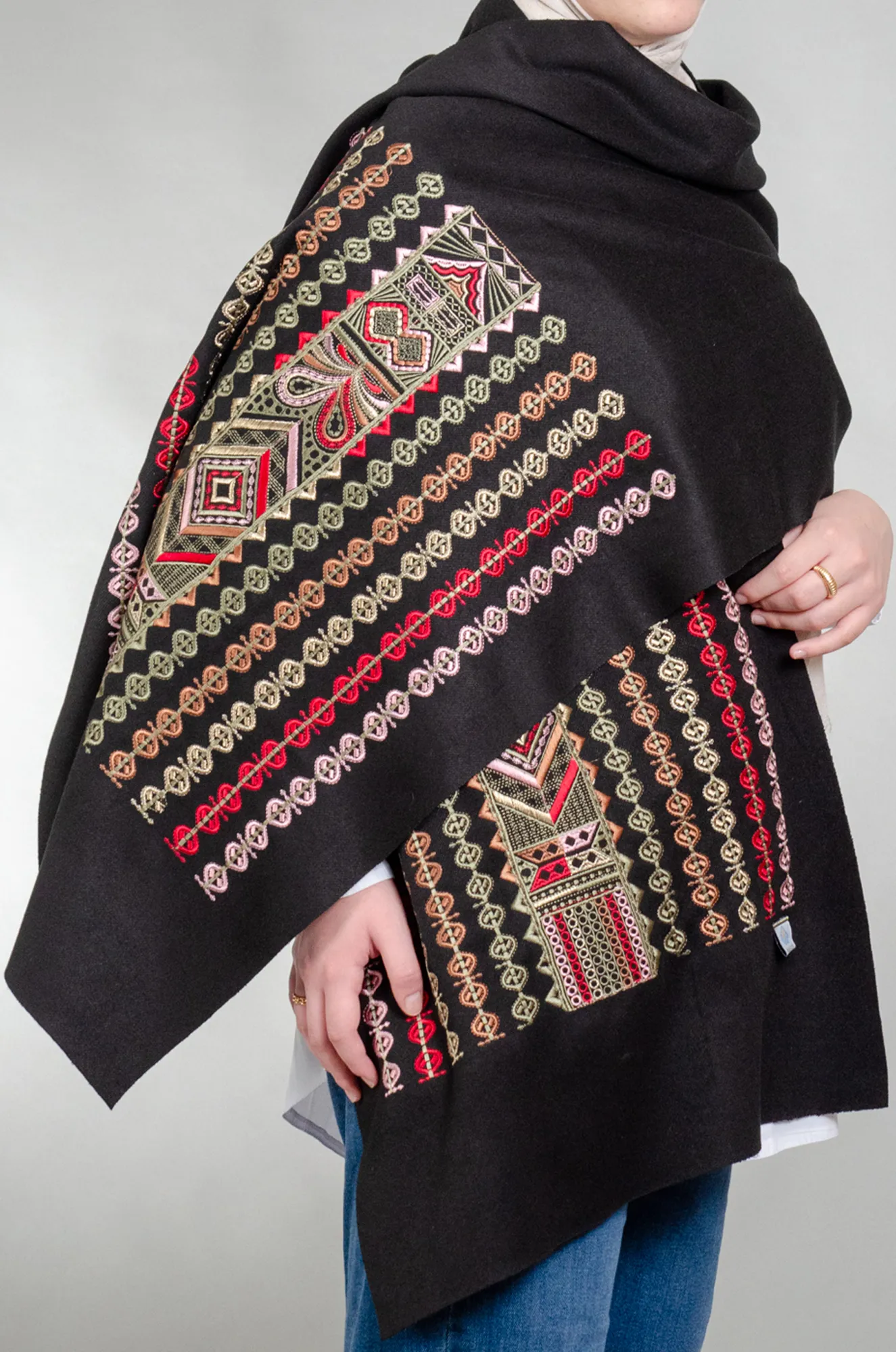 Black woolly shoulder shawl with olive green and pink Falahi medallion rows and geometric panel