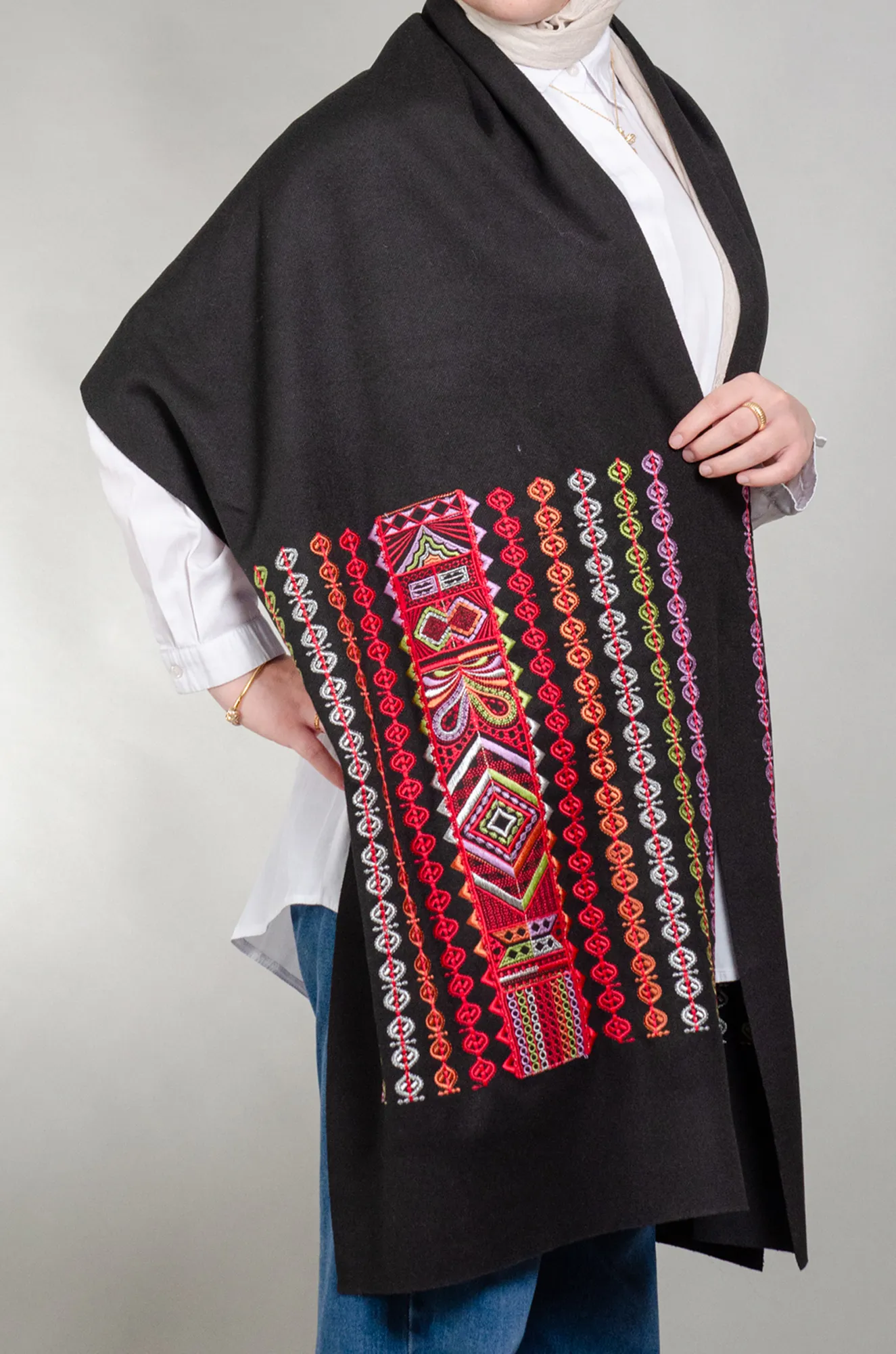 Black woolly shoulder shawl with red and orange Falahi medallion rows and geometric panel